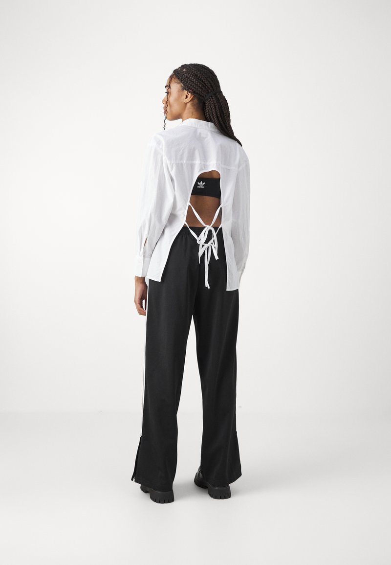 adidas Originals adidas Originals FBIRD LOOSE - Tracksuit bottoms - black Fabrik Onlineshop