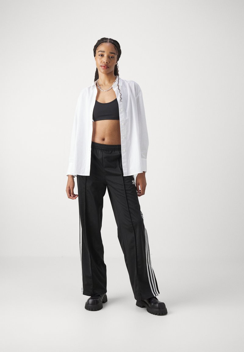adidas Originals adidas Originals FBIRD LOOSE - Tracksuit bottoms - black Fabrik Onlineshop