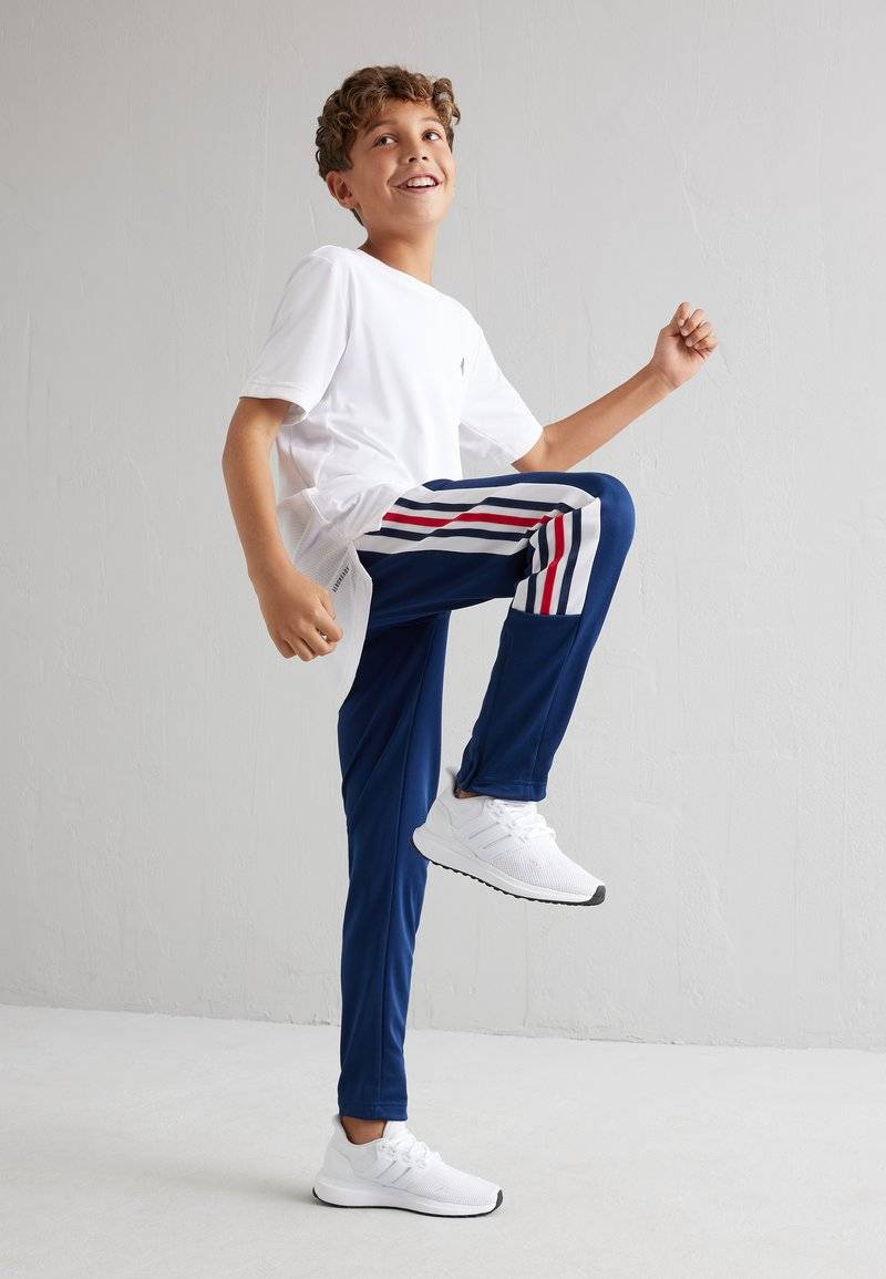adidas Performance adidas Performance TIRO NATIONS PACK UNISEX - Tracksuit bottoms Jubiläumsangebot