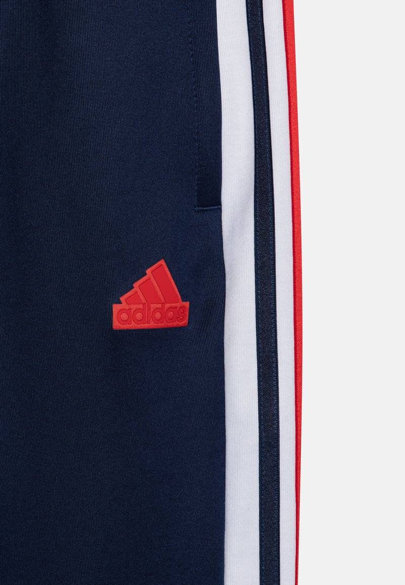 adidas Performance adidas Performance TIRO NATIONS PACK UNISEX - Tracksuit bottoms Jubiläumsangebot