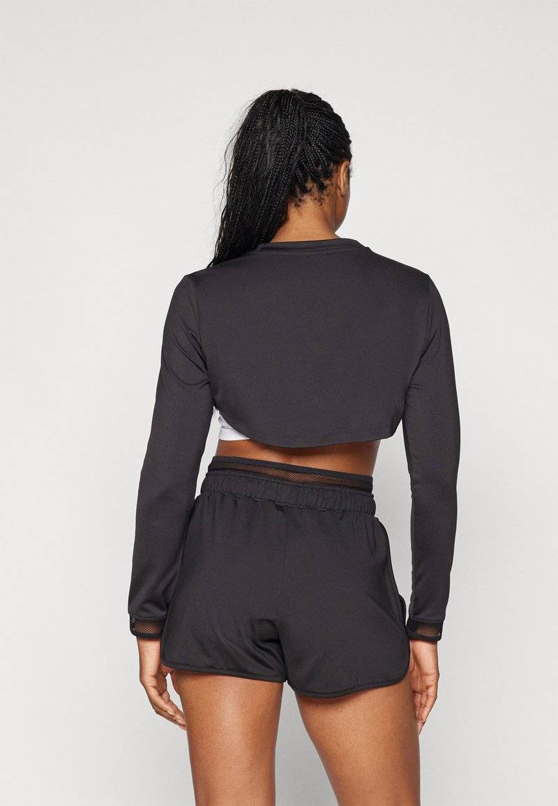 Puma Puma PAMELA REIF CROPPED - Long sleeved top - black Muttertagsangebot