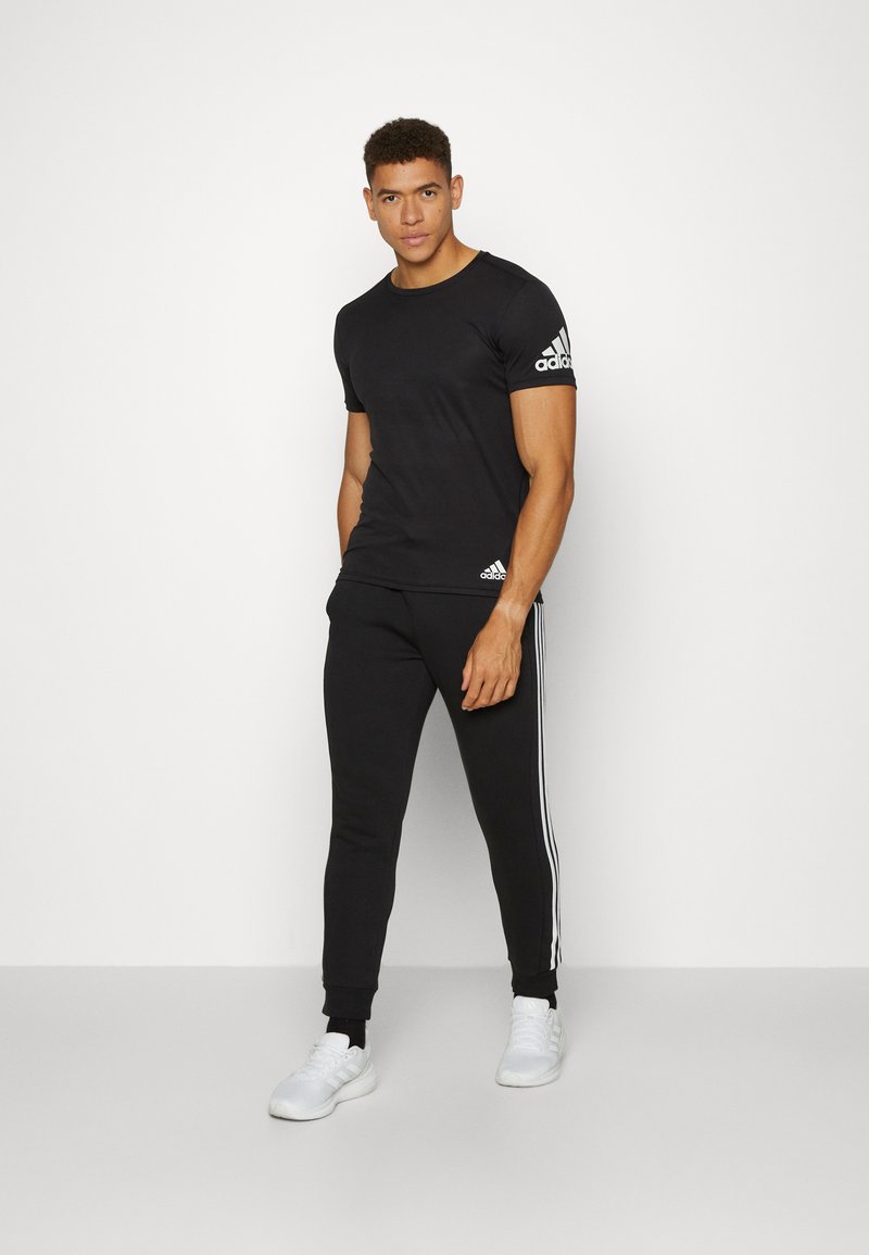 adidas Sportswear adidas Sportswear ESSENTIALS TAPERED CUFF 3 STRIPES PANTS - Tracksuit bottoms - black white Blitzangebot