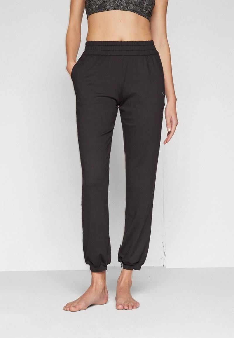 Puma Puma STUDIO FOUNDATIONS - Tracksuit bottoms - black Lagerräumung