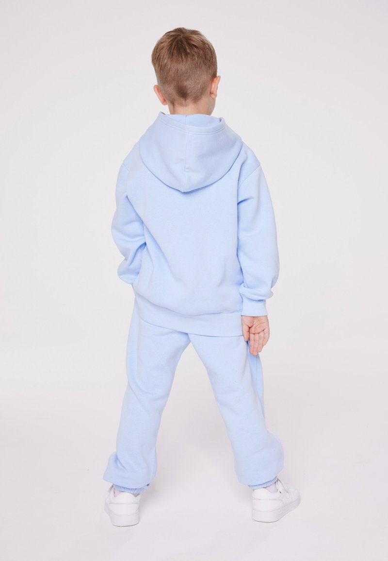 Champion Champion EXCLUSIVE PANT UNISEX - Tracksuit bottoms - light blue Vierteljährliche Förderung