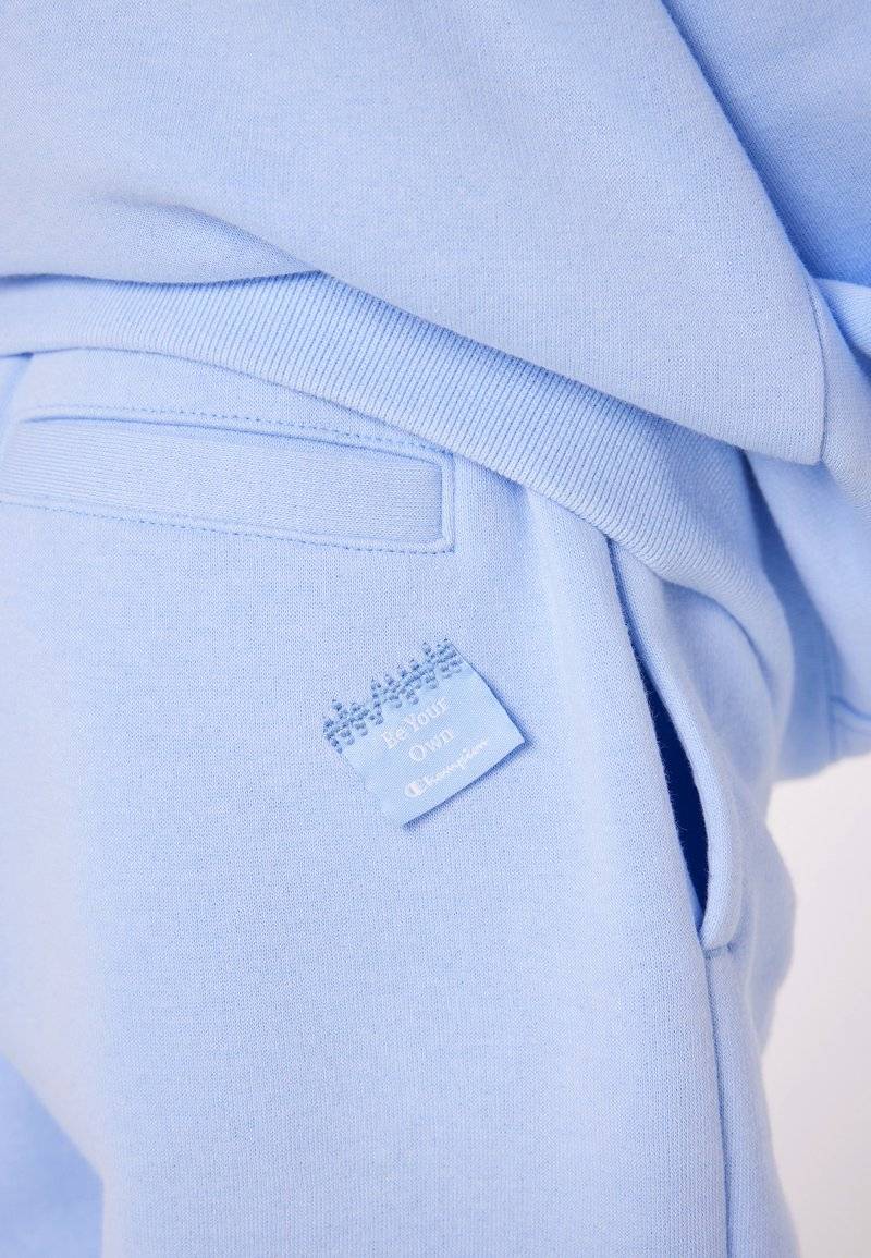 Champion Champion EXCLUSIVE PANT UNISEX - Tracksuit bottoms - light blue Vierteljährliche Förderung